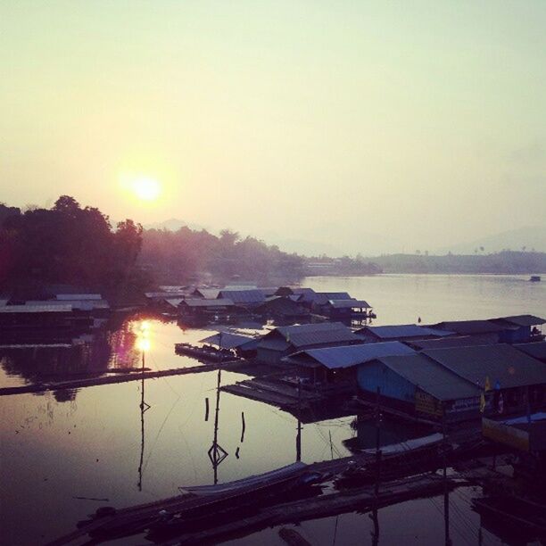 VIEW OF BOATS IN SEA AT SUNSET