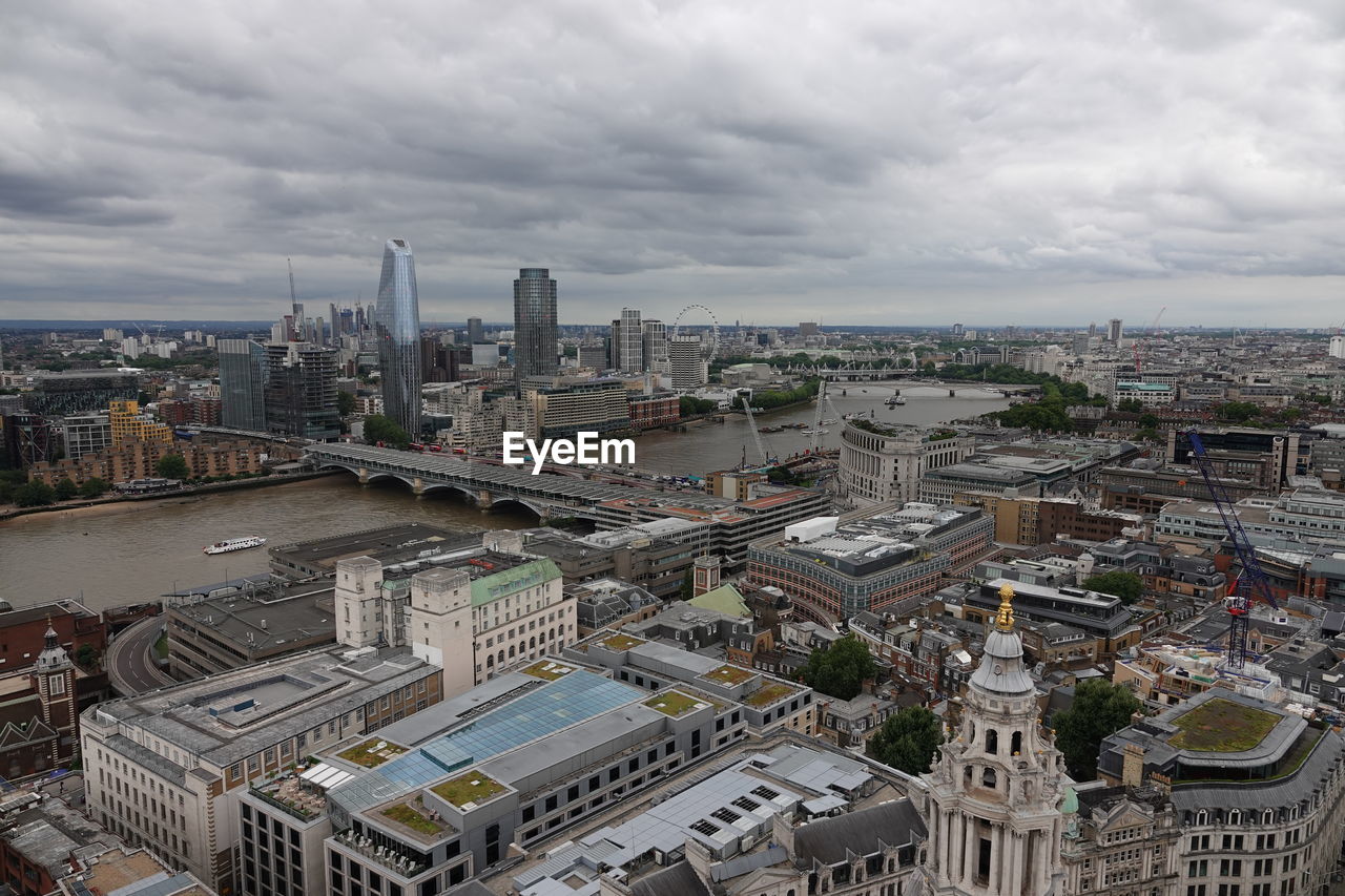 High angle view of city buildings against cloudy sky in city of london 