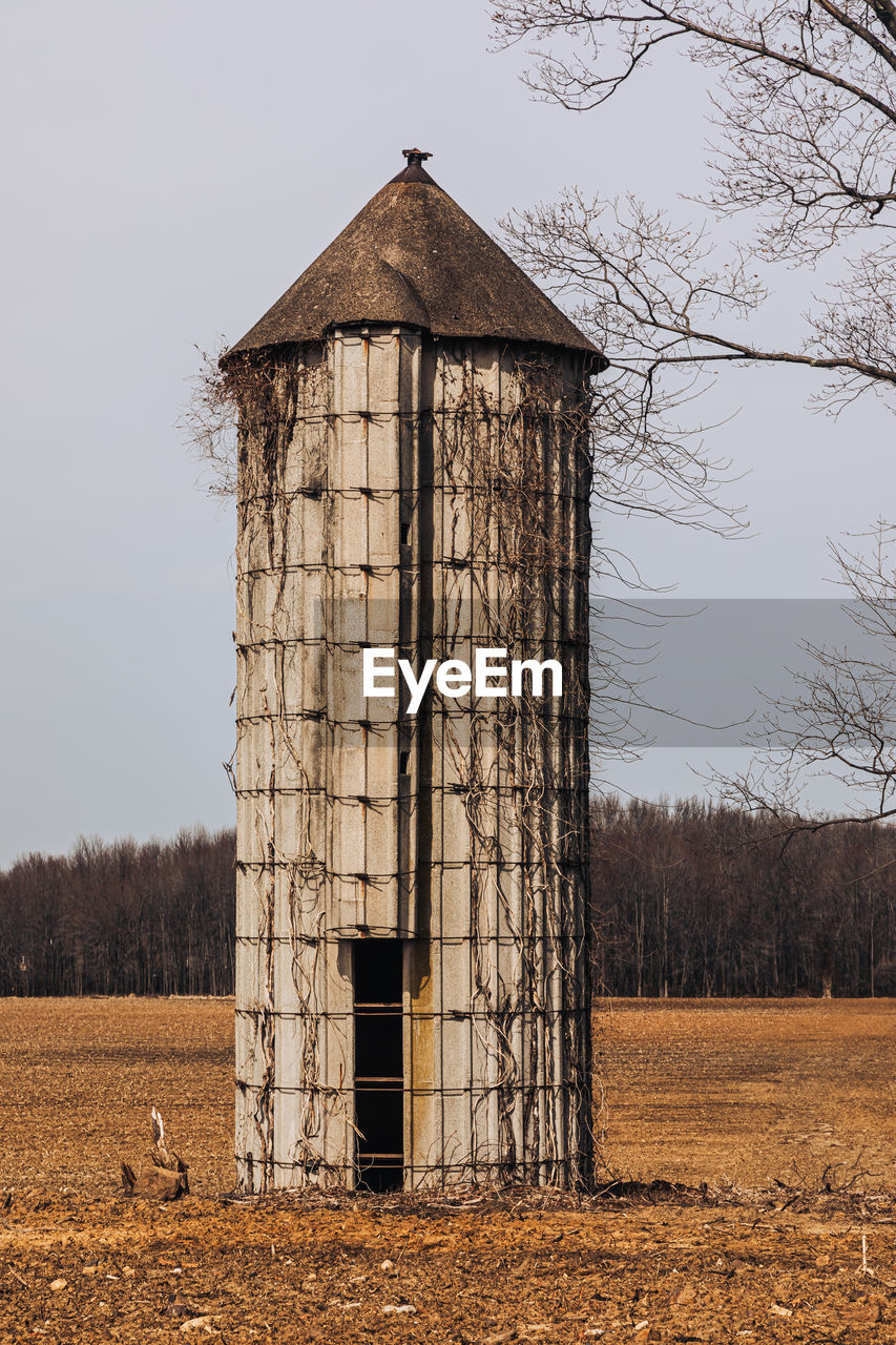 Old  silo on field against sky