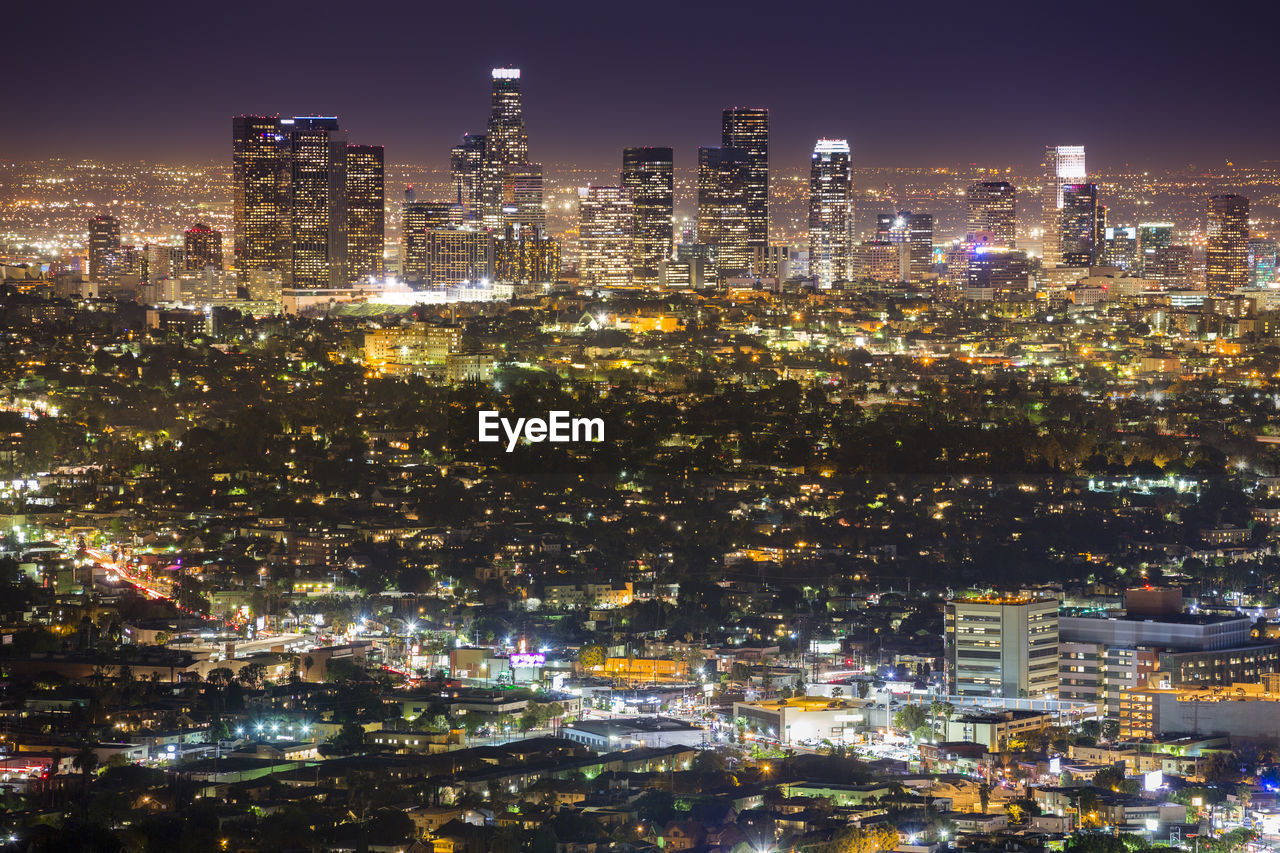 High angle view of city lit up at night