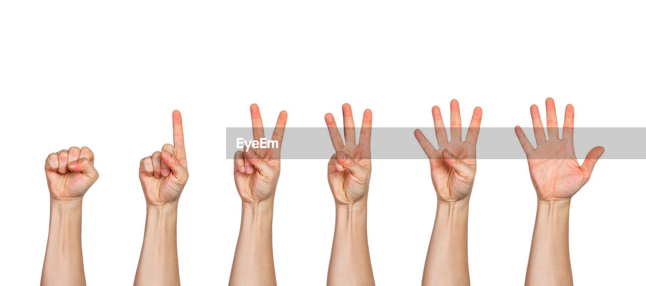 Close-up of cropped hands gesturing against white background