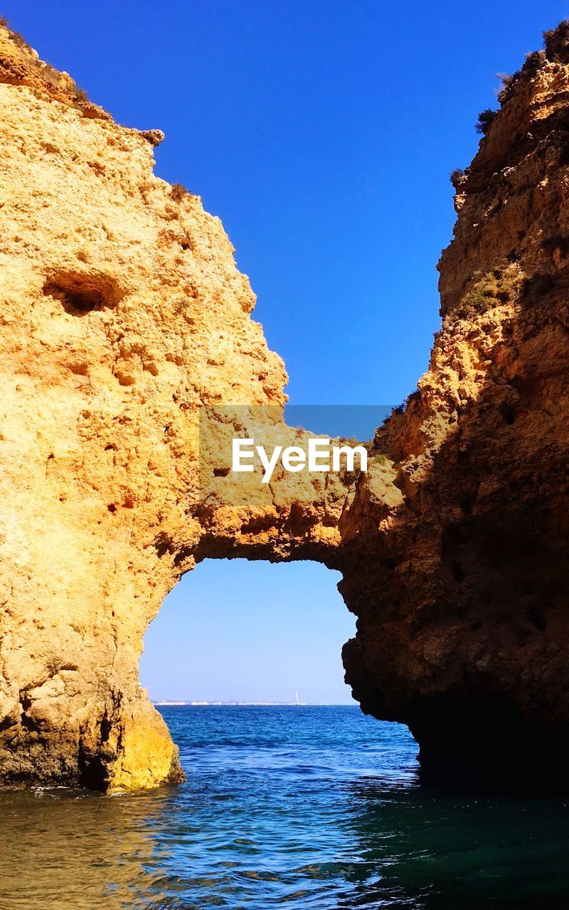 SCENIC VIEW OF ROCK FORMATION AGAINST CLEAR BLUE SKY