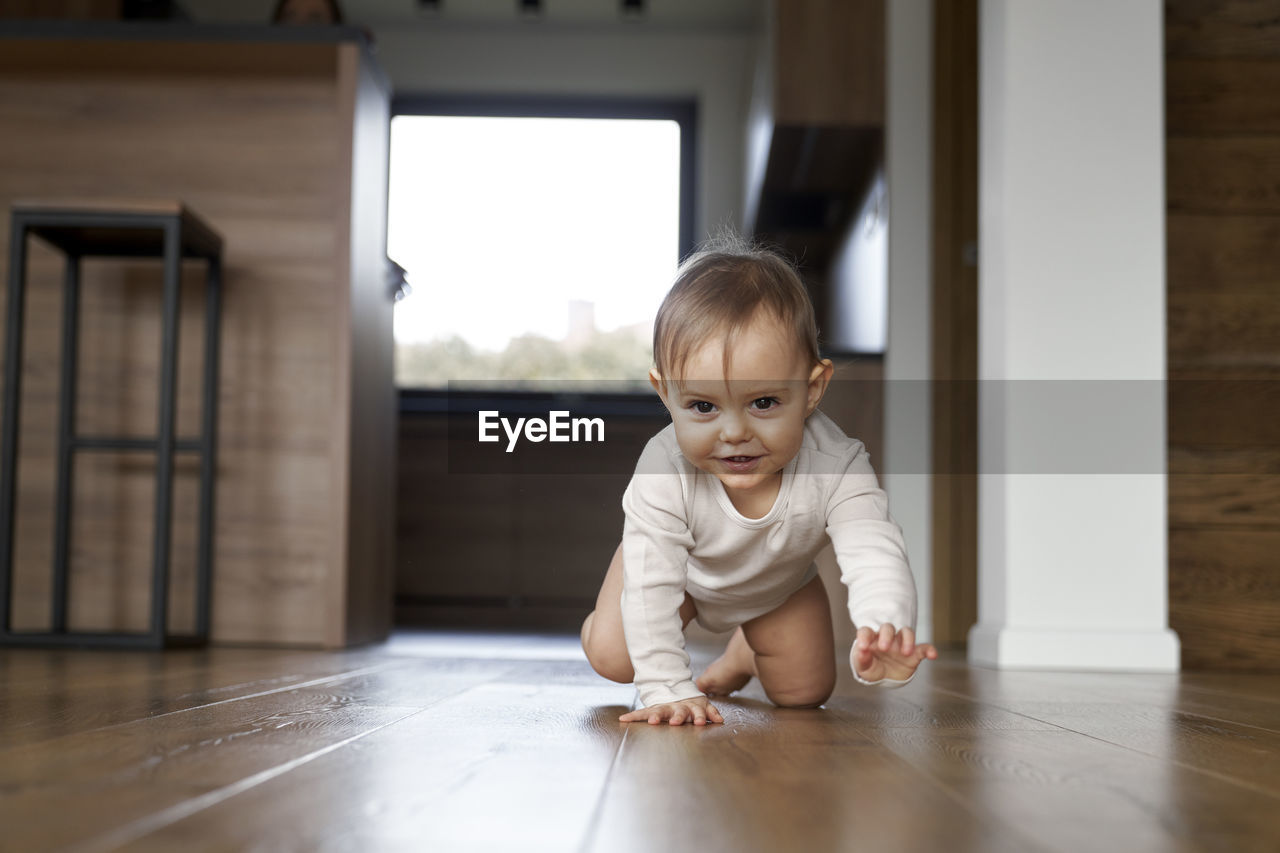 portrait of cute boy sitting on floor