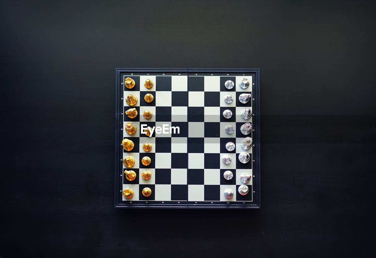 High angle view of chess board on black background