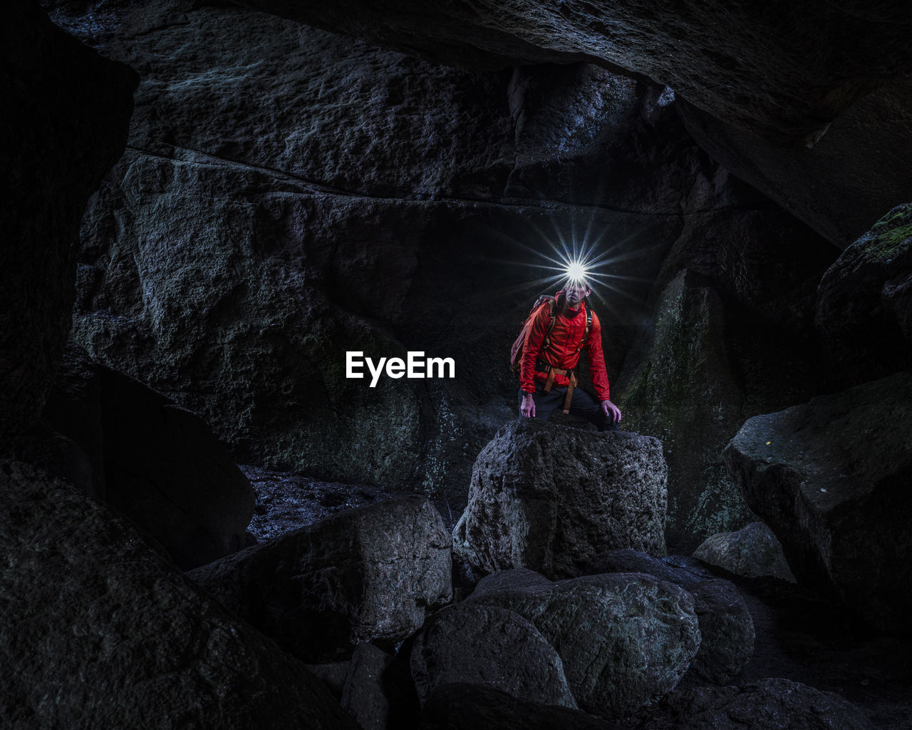 Man with headlamp exploring cave