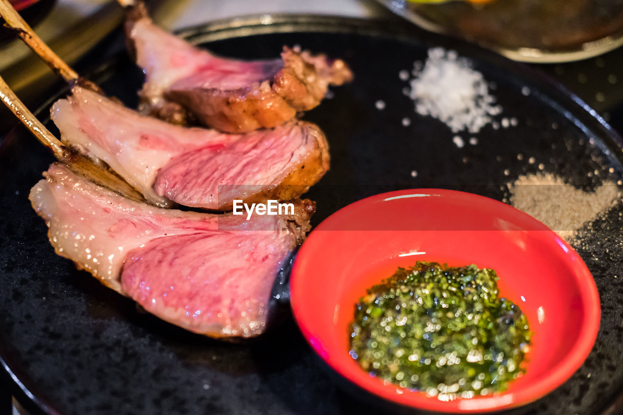 Smoked australian lamb chops steak served on plate with sauce