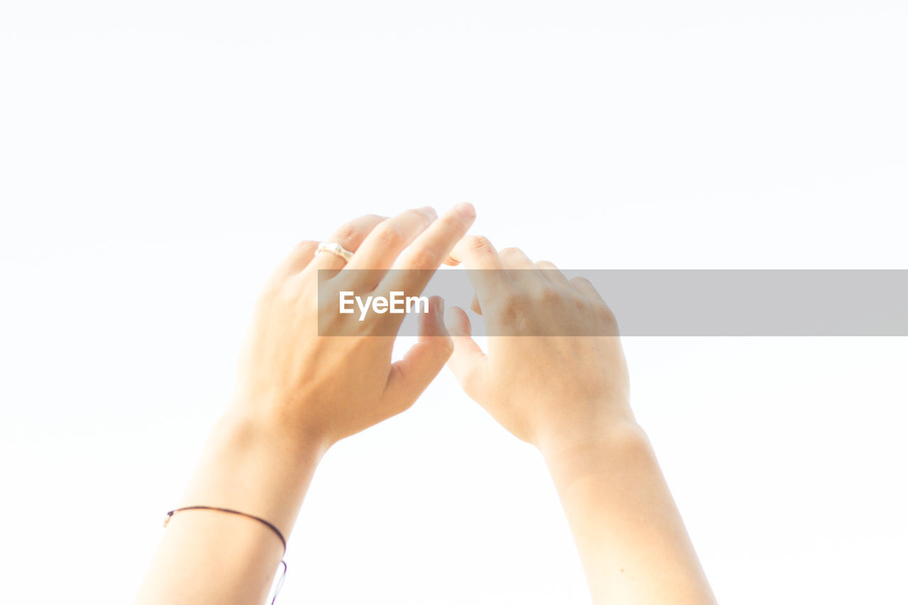 Cropped hands against white background