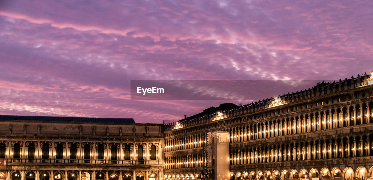 Low angle view of illuminated piazza san marco at dusk