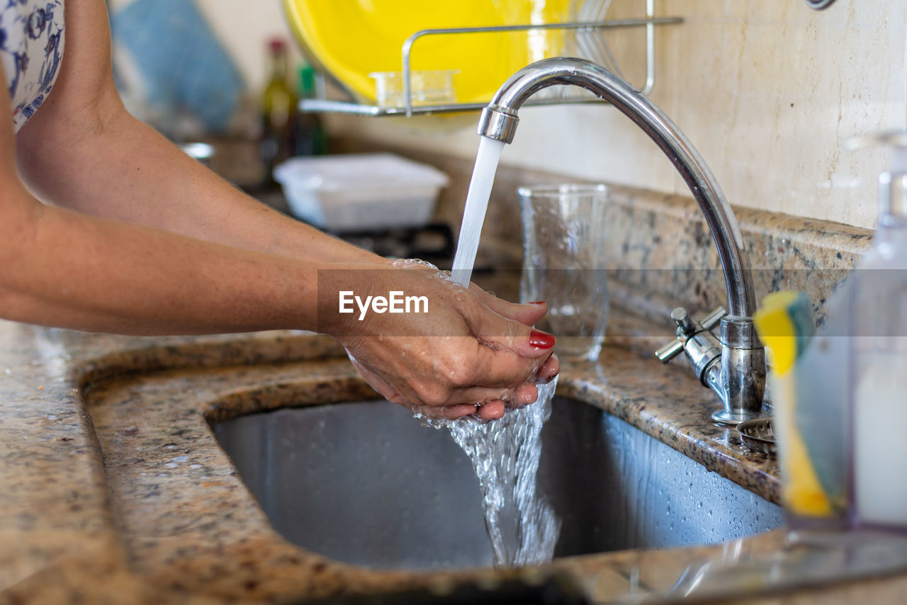 Person washing hands before cooking. healthy eating