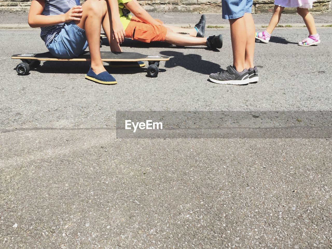 Low section of kids with skateboard in park