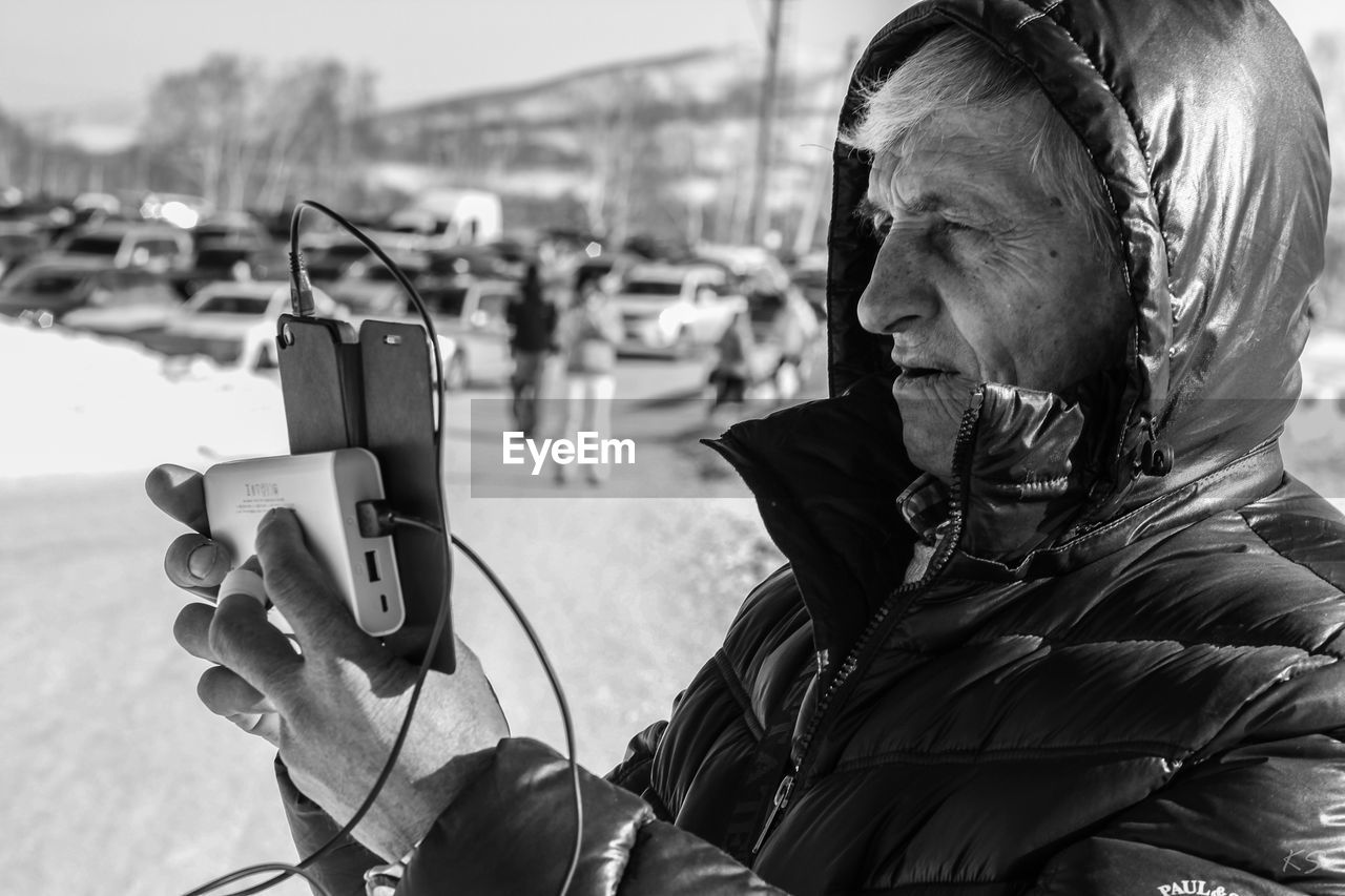 CLOSE-UP OF MAN PHOTOGRAPHING WITH CAMERA