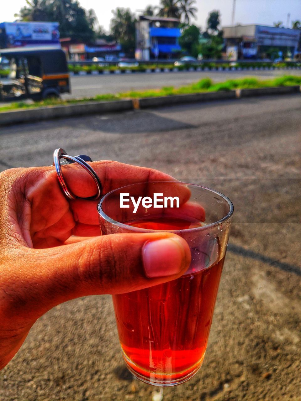 CLOSE-UP OF HAND HOLDING GLASS OF RED