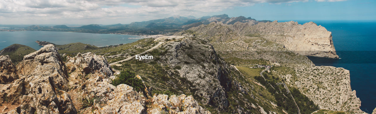 Panoramic view of sea and mountains against sky