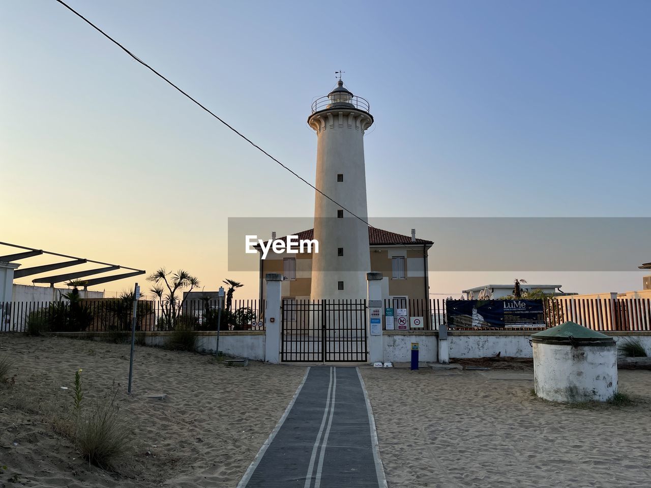 architecture, built structure, building exterior, sky, tower, building, lighthouse, nature, clear sky, travel destinations, city, water, sea, travel, landmark, guidance, no people, outdoors, land, sunset, street, beach, blue, transportation, coast, walkway, history, tourism, the past, day