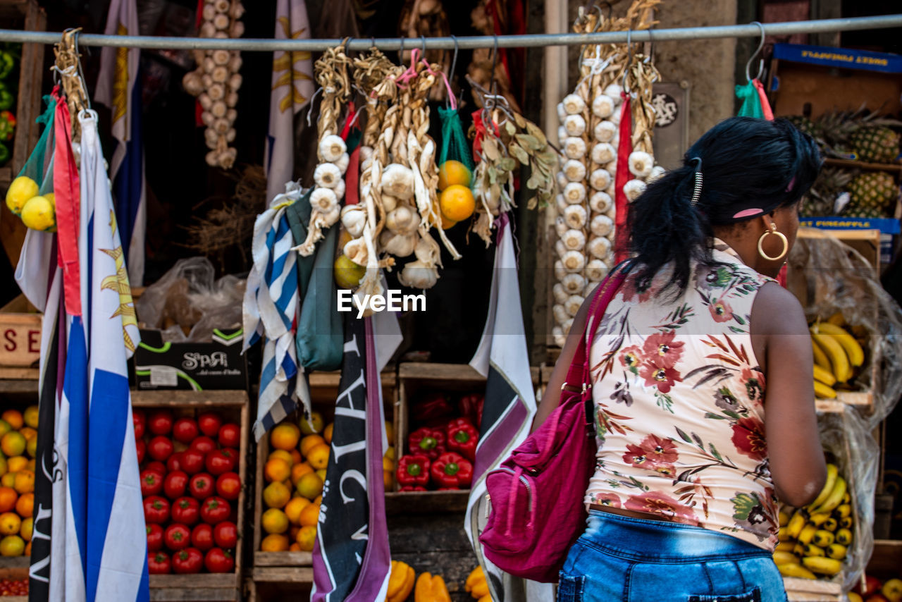 FULL LENGTH OF WOMAN STANDING IN MARKET