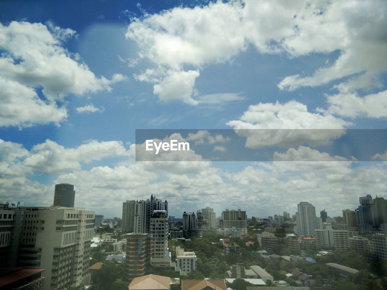 SKYSCRAPERS AGAINST CLOUDY SKY