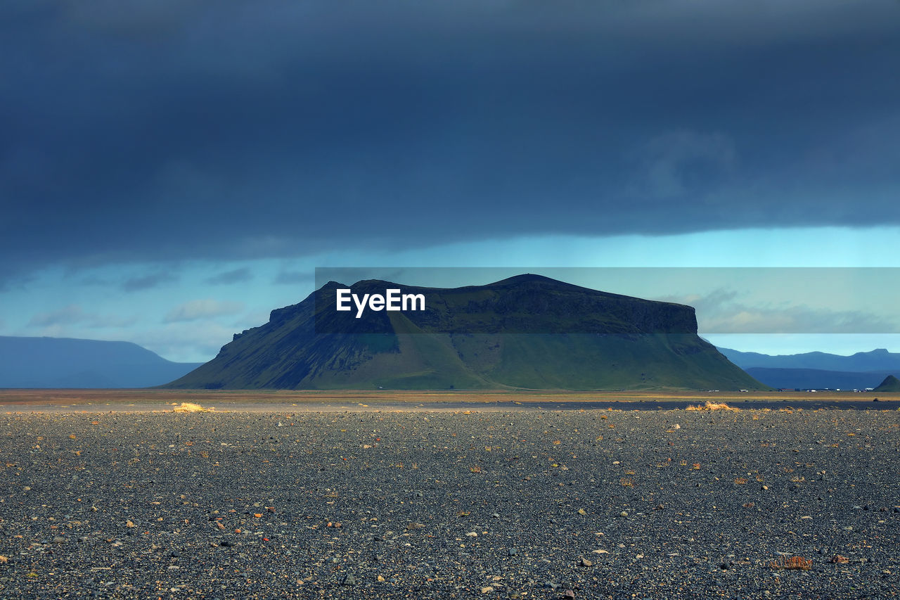 Scenic view of mountain against cloudy sky