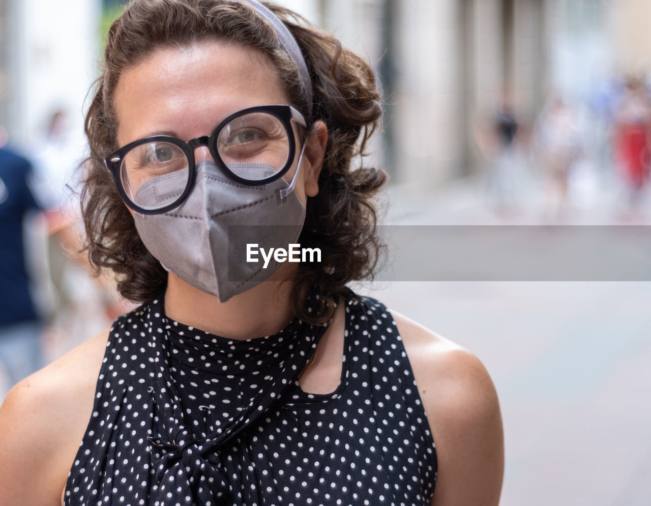 Portrait of young woman wearing mask and eyeglasses