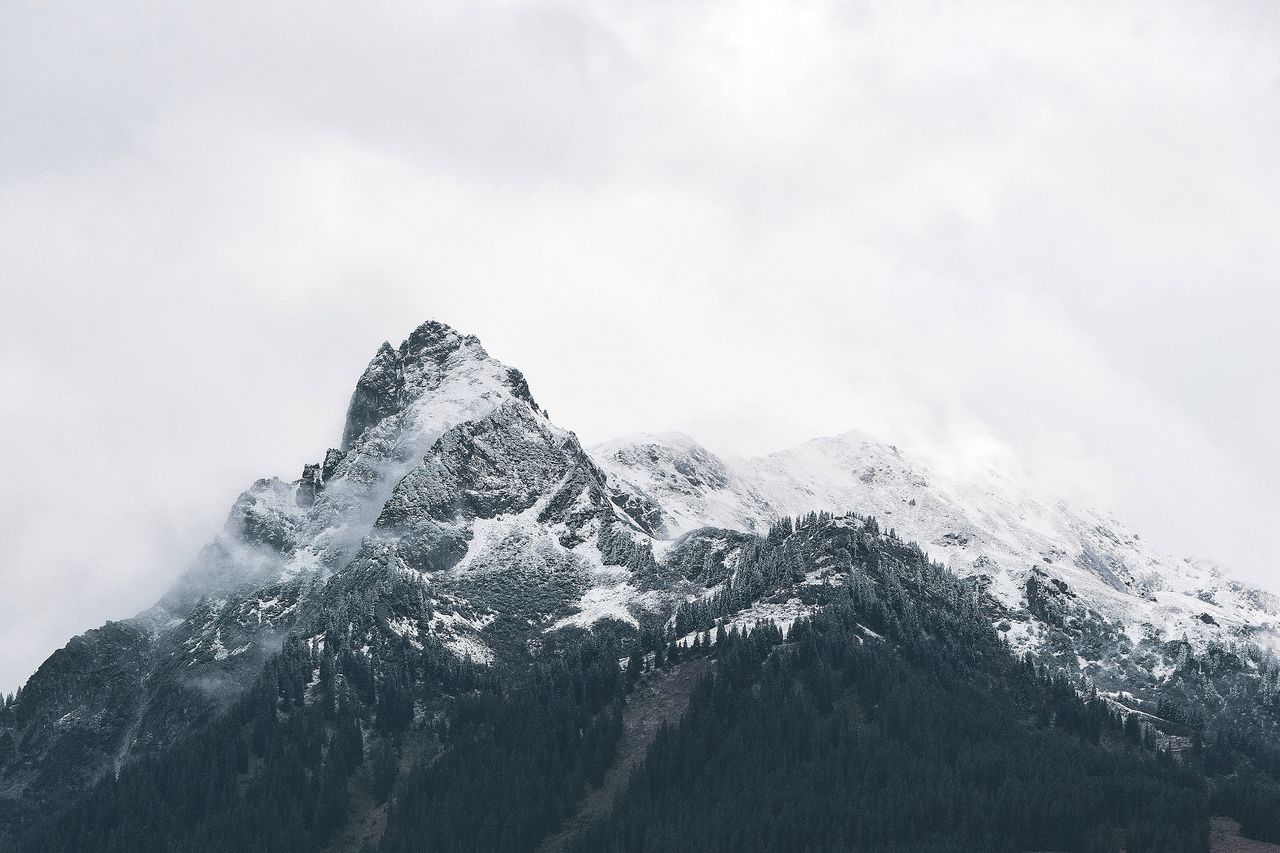 TILT IMAGE OF SNOWCAPPED MOUNTAIN AGAINST SKY