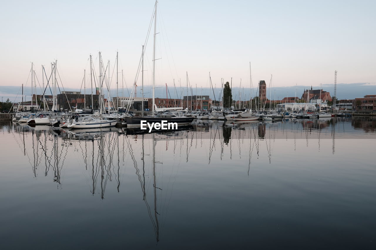 SAILBOATS MOORED IN MARINA