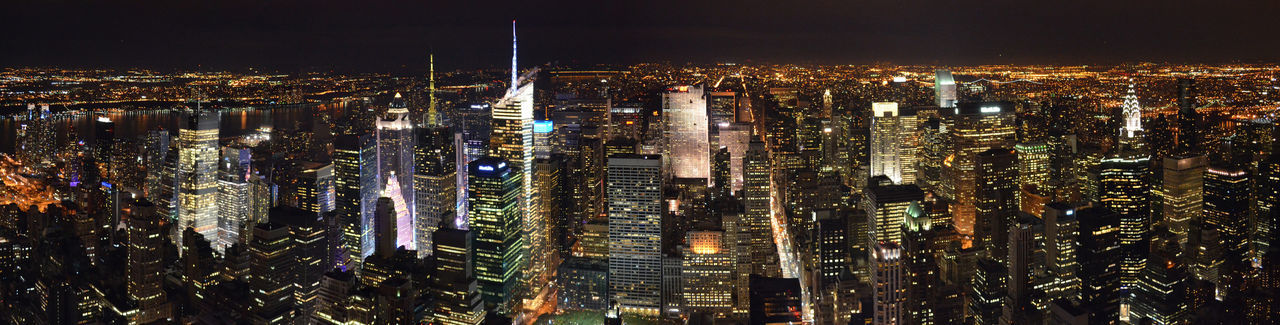 Illuminated modern buildings in city at night