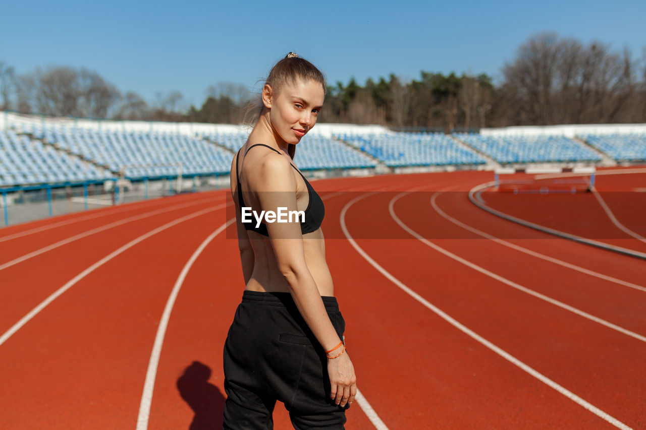 Woman exercising on sports track