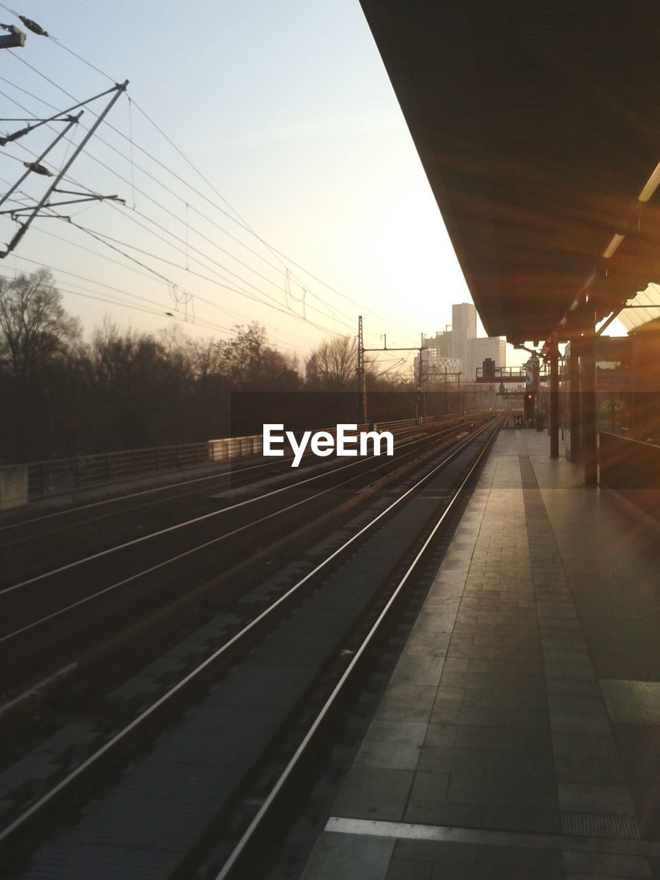 RAILROAD TRACKS SEEN THROUGH TRAIN WINDSHIELD