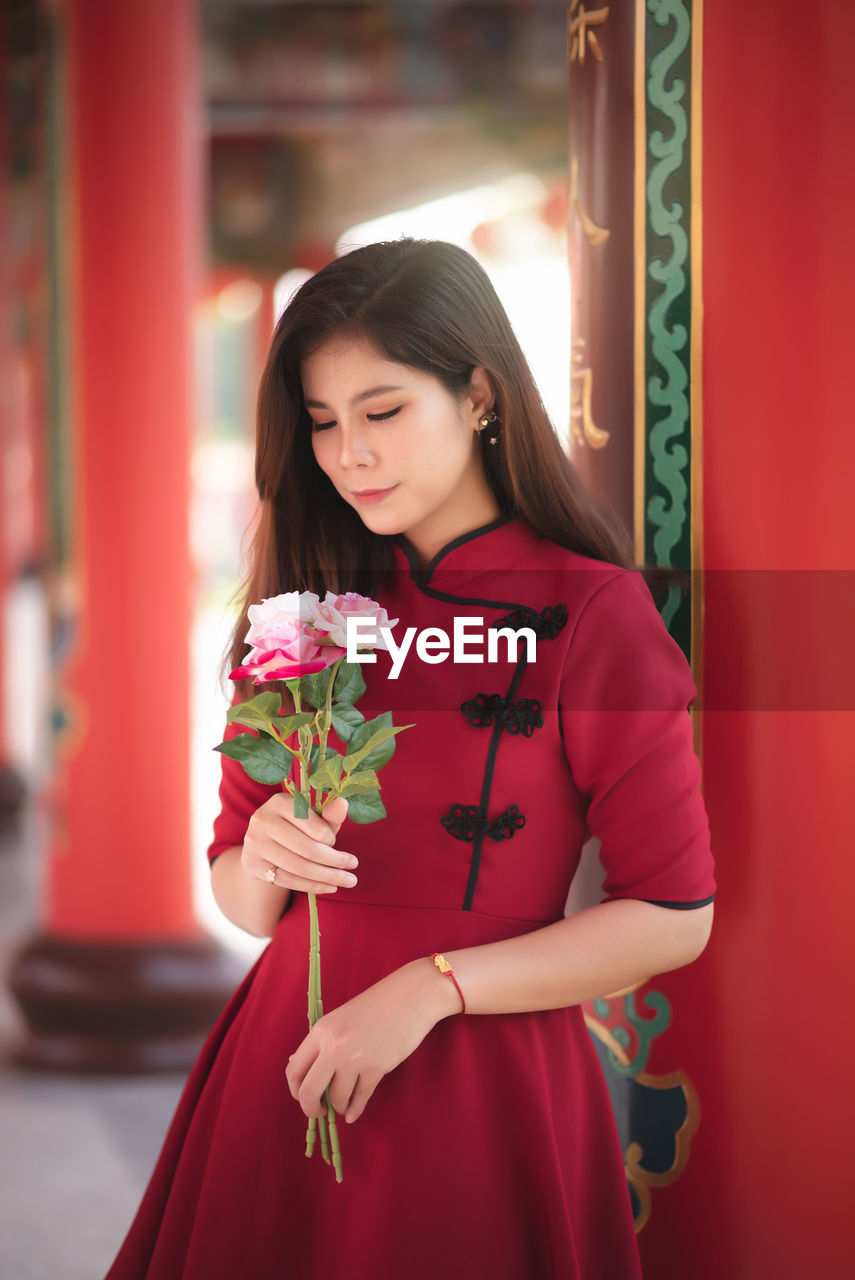 Young woman holding flower bouquet