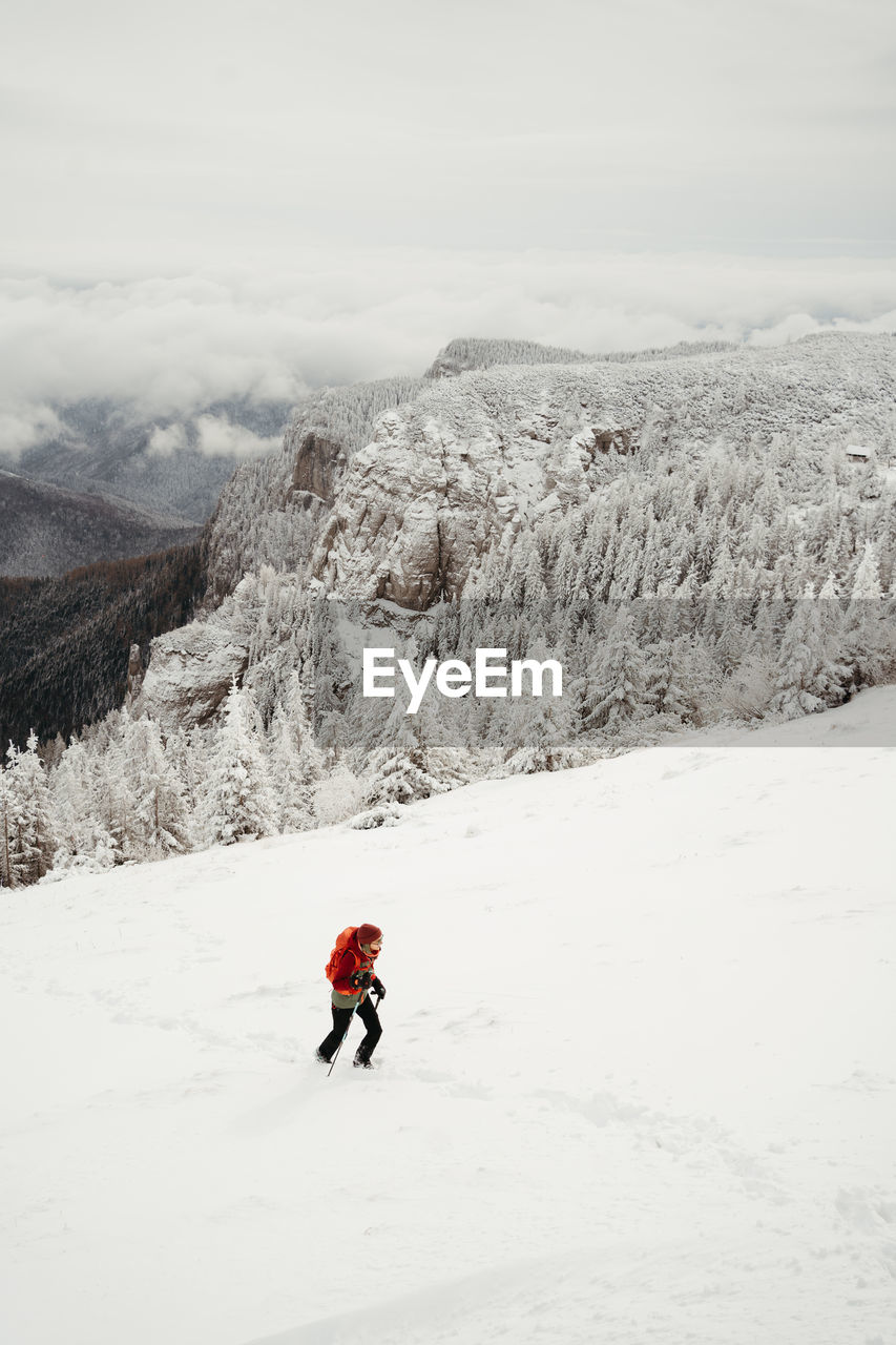 rear view of man skiing on snow covered mountain