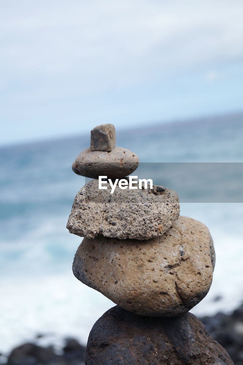 Stack of stones against beach