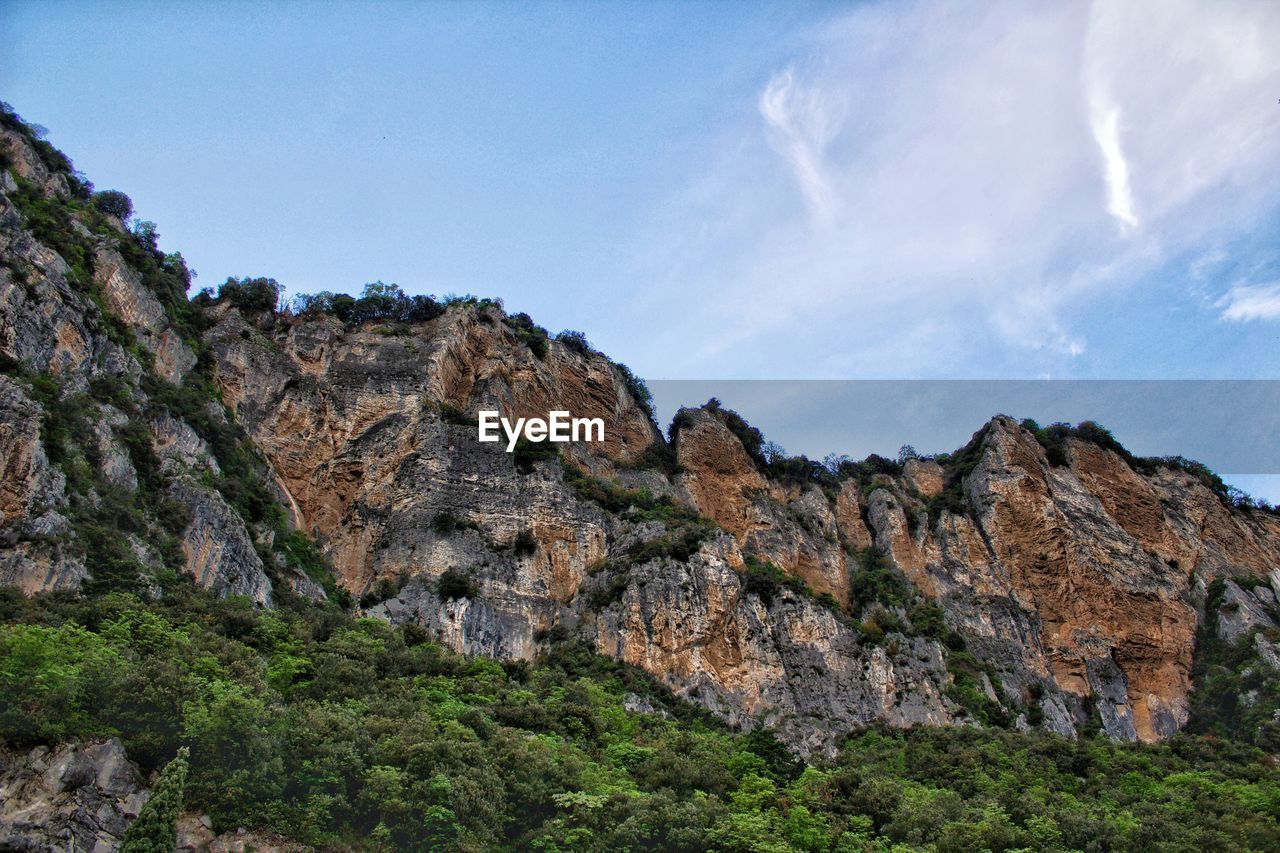 Low angle view of rock formation against sky