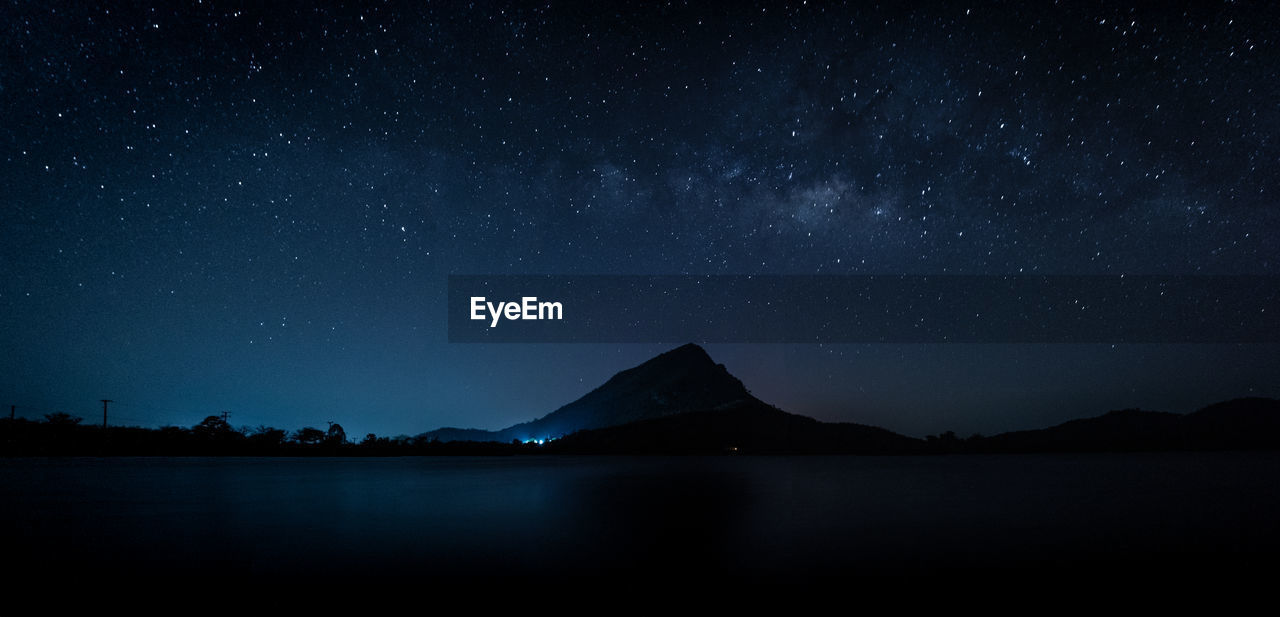 Scenic view of lake against star field at night