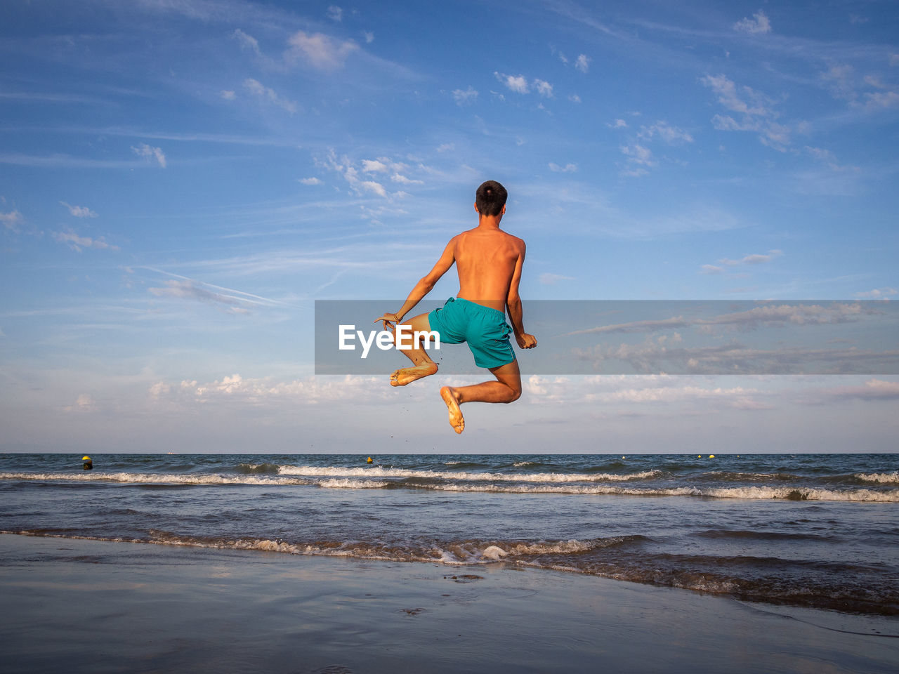 full length of woman standing at beach