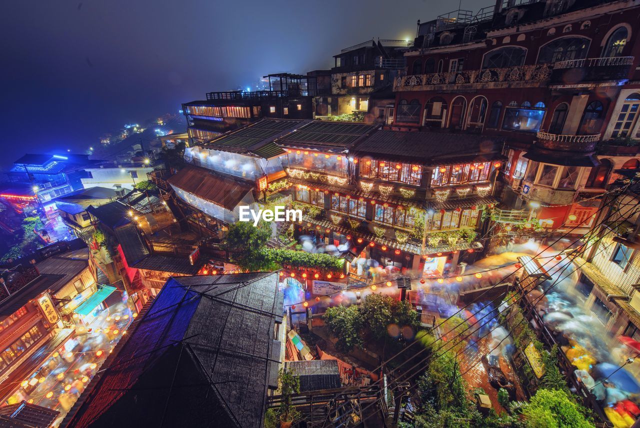 High angle view of buildings in city at night