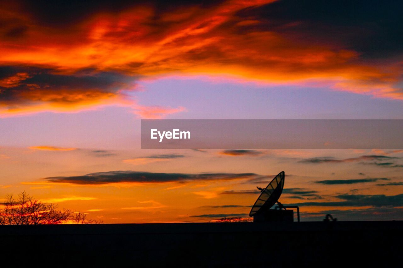 Silhouette landscape against scenic sky