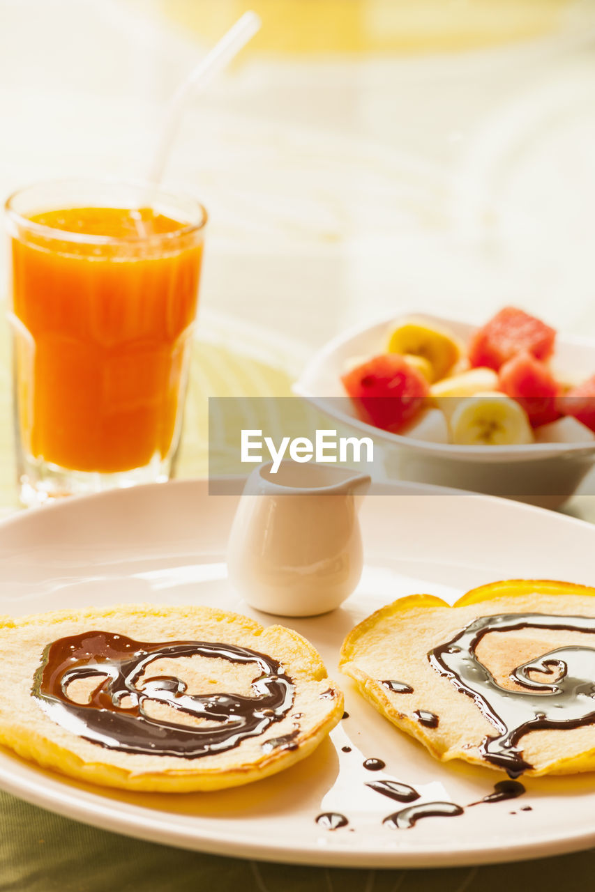 Breakfast plate with pancakes and fruit bowl in yangshuo