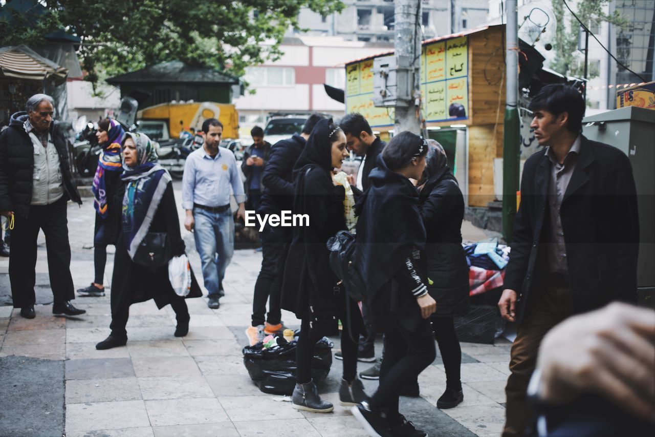 GROUP OF PEOPLE WALKING ON FOOTPATH