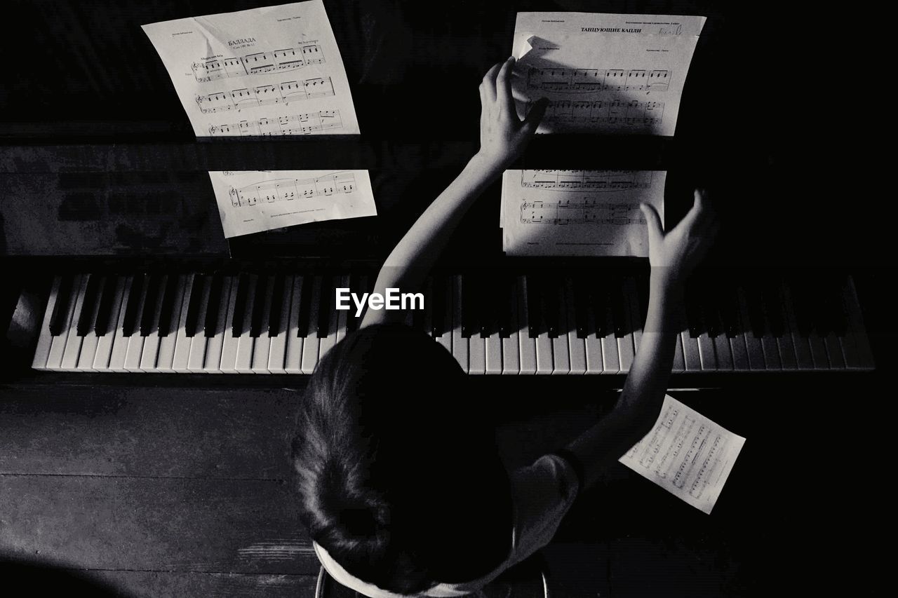 High angle view of boy playing piano