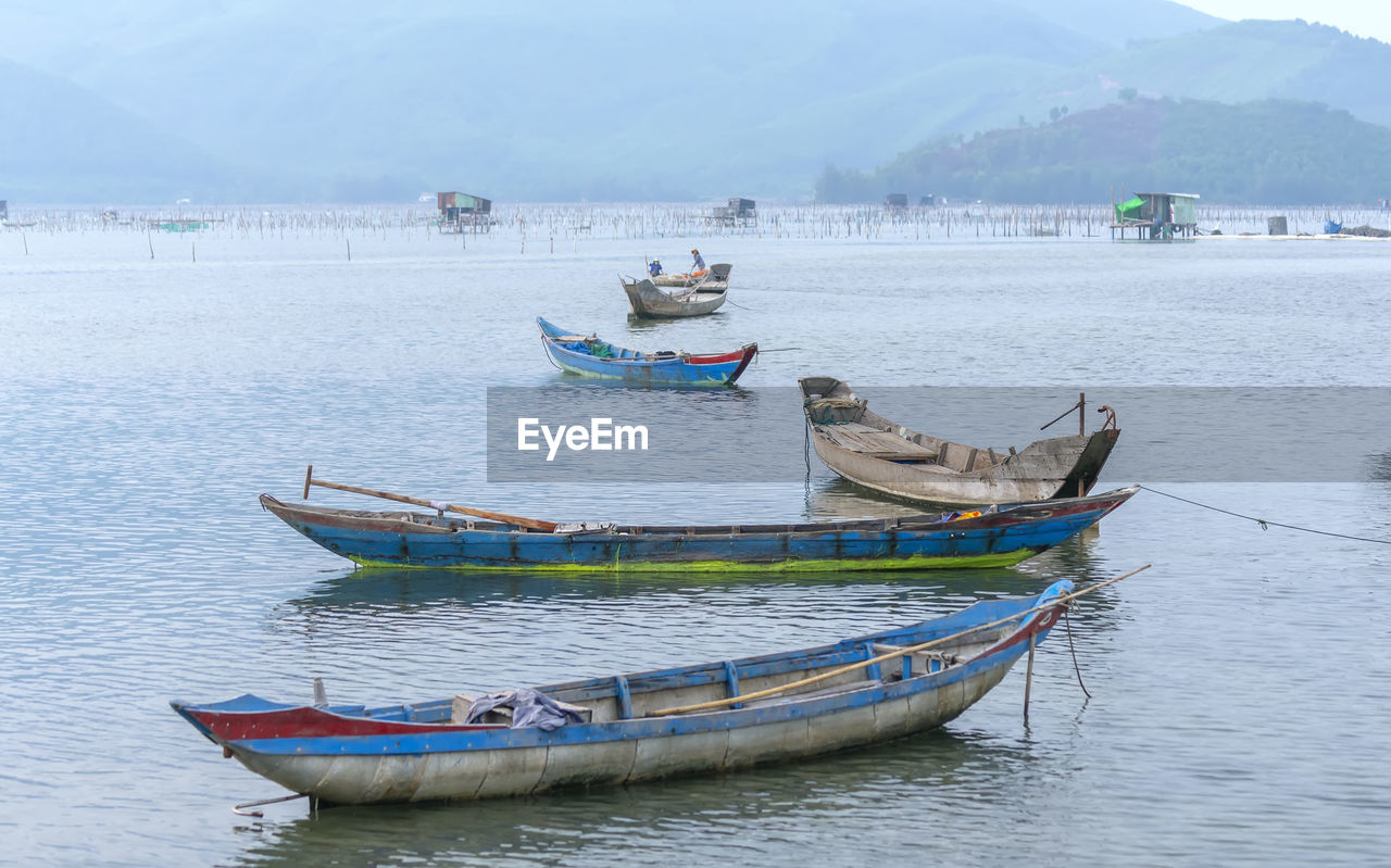 BOATS MOORED ON SEA