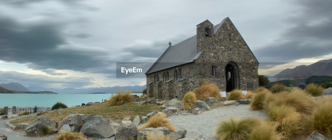 Historic building by mountains against sky