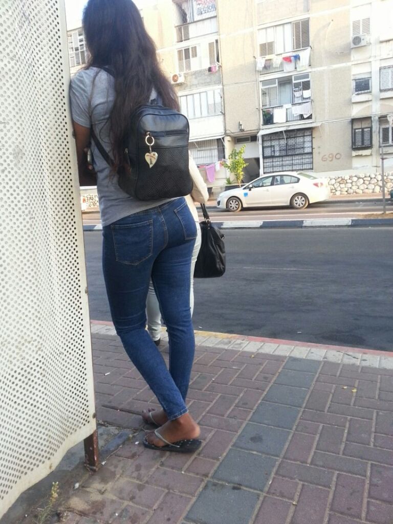 WOMAN STANDING ON CITY STREET