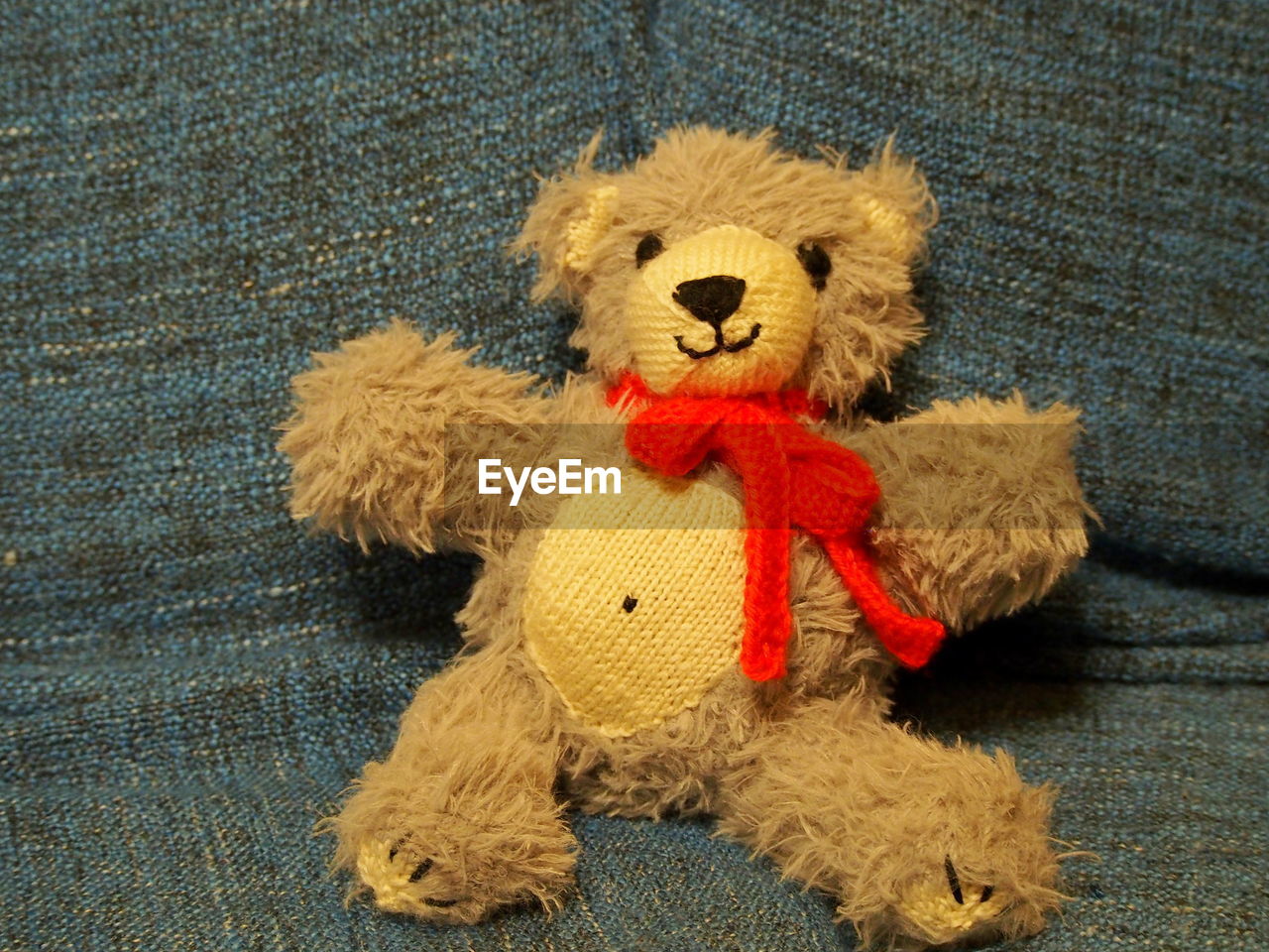 High angle view of teddy bear on textile