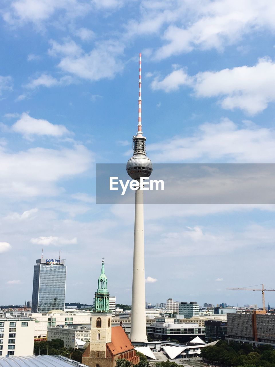 Fernsehturm and cityscape against sky