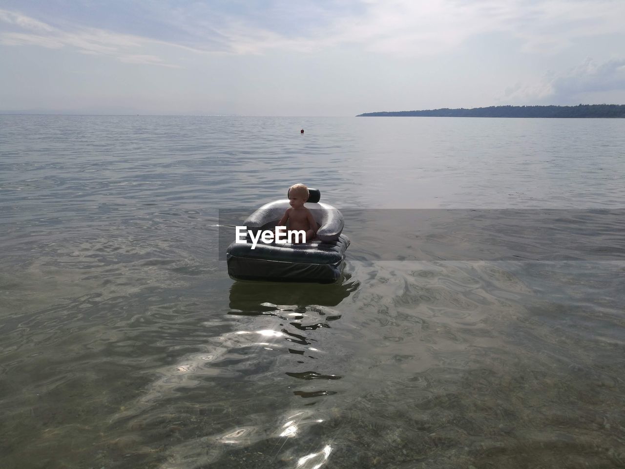 Rear view of man on sea against sky