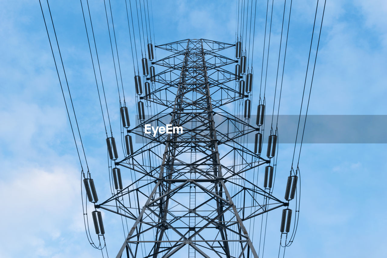 Low angle view of electricity pylon against sky