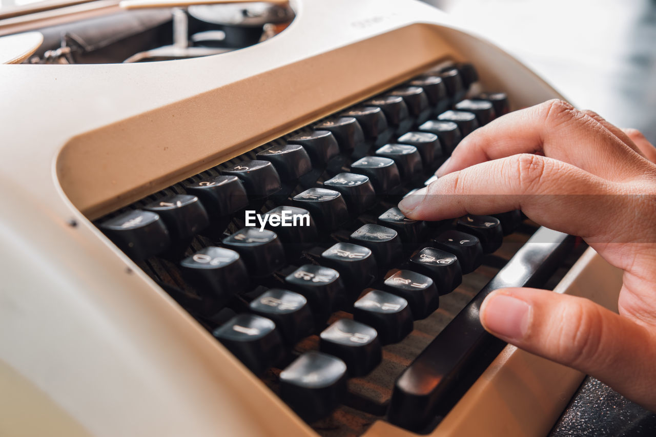 Cropped hand using typewriter