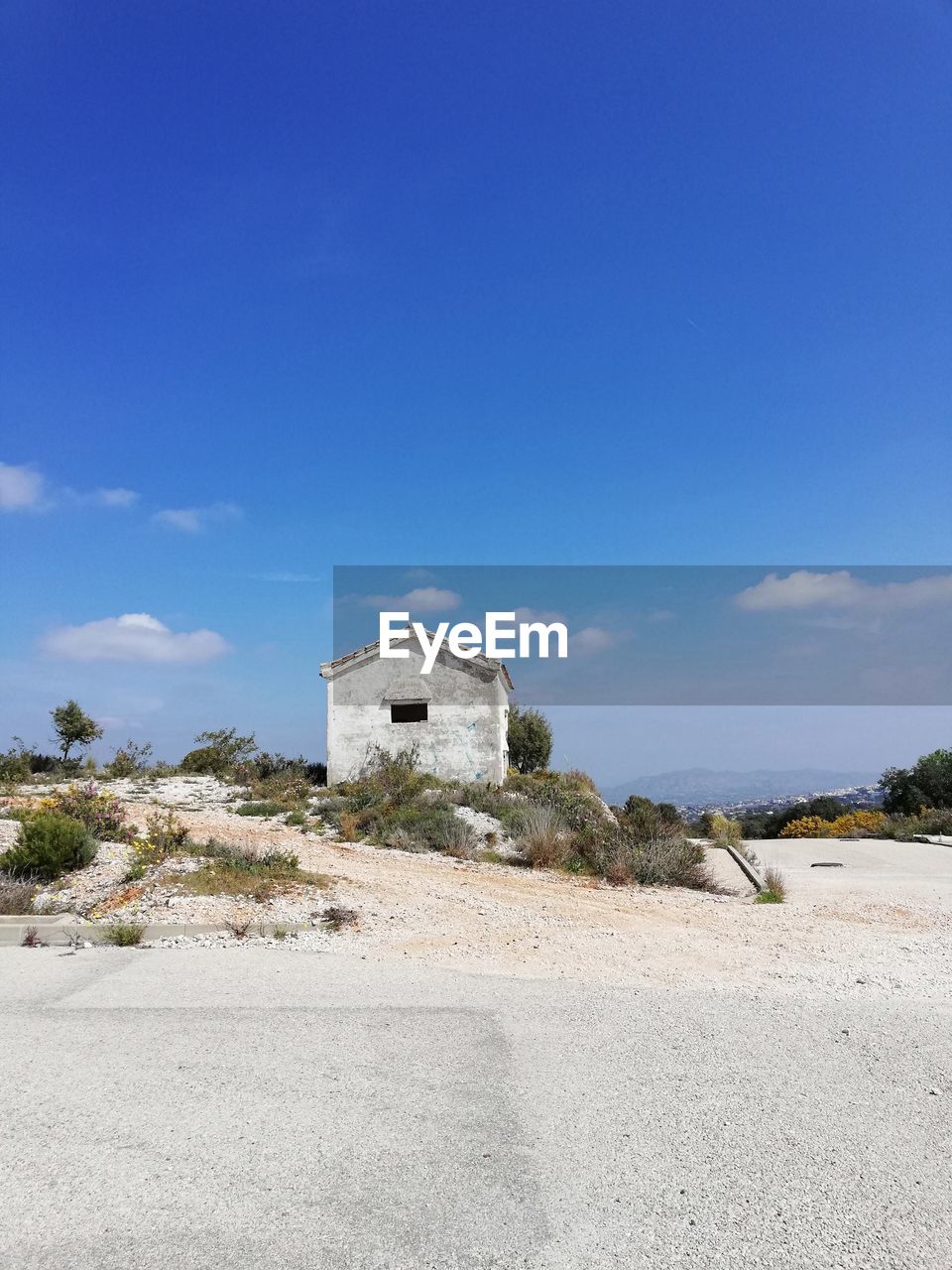 Built structure on beach against blue sky