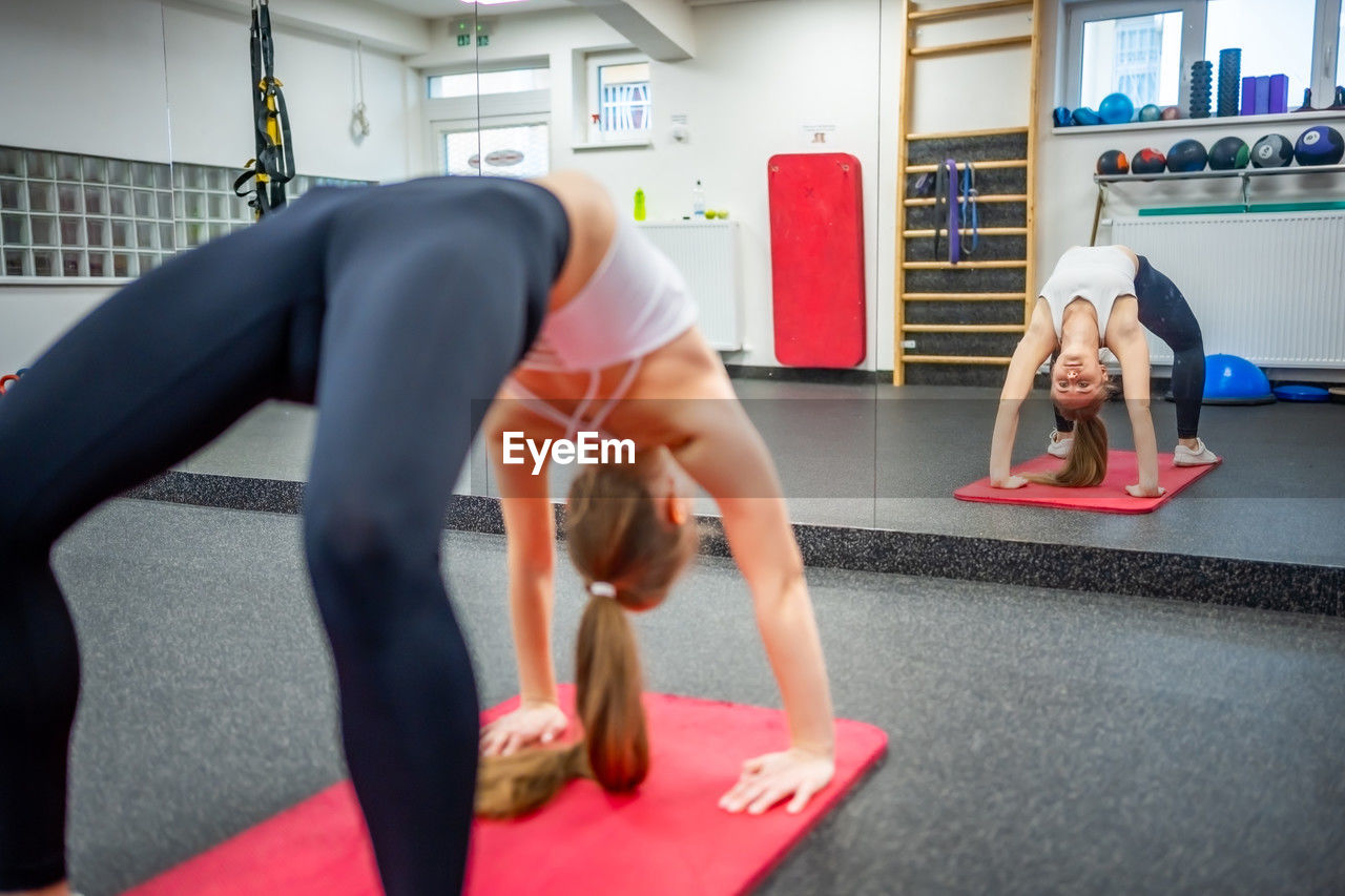 full length of woman exercising in gym