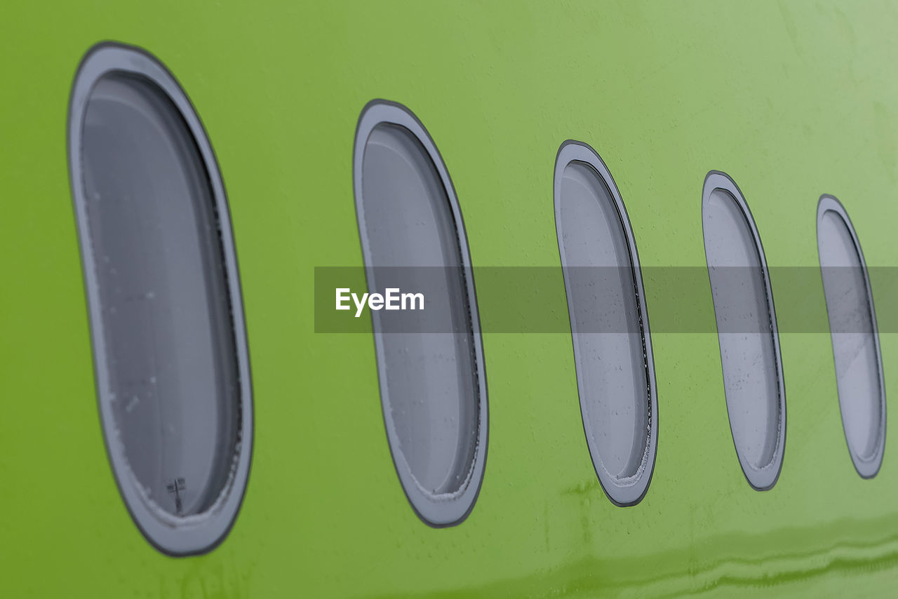 font, green, no people, automotive exterior, close-up, text, symbol, indoors, communication, number, panoramic