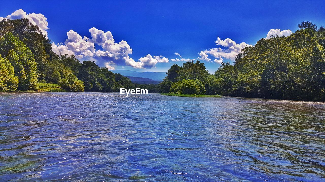 Scenic view of lake against blue sky